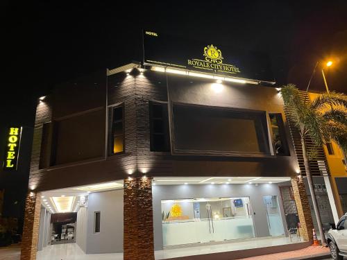 a restaurant with a sign on top of it at night at Royale City Hotel - 10 min from KLIA KLIA 2 Airport in Sepang