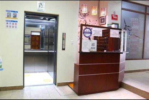 a store with a display case in a room at Hotel Villonaco in Loja