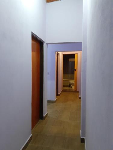 a hallway with white walls and a tile floor at La Candela 1 casa in Villa Lonca