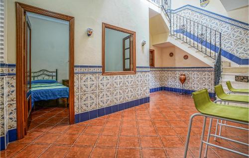 a hallway with blue and white tiled walls and stairs at Gorgeous Home In Algamitas With Wifi in Algámitas