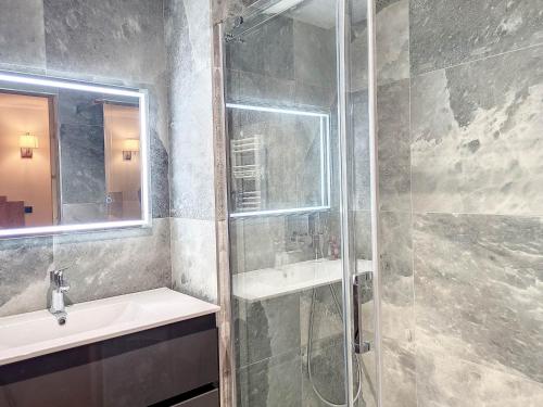 a bathroom with a shower and a sink and a mirror at Appartement Montvalezan-La Rosière, 5 pièces, 8 personnes - FR-1-275-186 in La Rosière