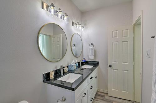 a bathroom with a sink and a mirror at Bright and Breezy Galveston Retreat with Deck! in Galveston