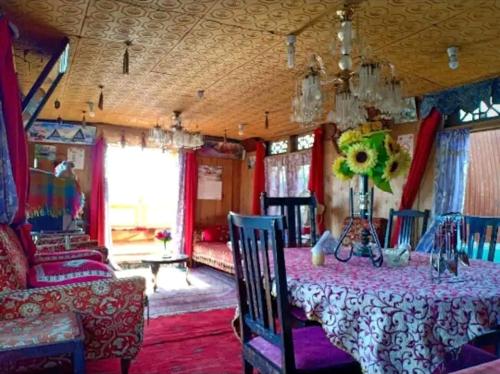 - une salle à manger avec une table et un canapé dans l'établissement H.B.victoria Garden, à Srinagar