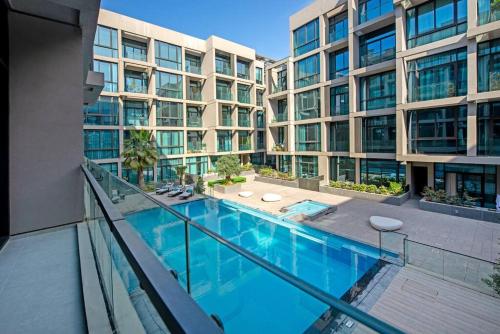 a swimming pool in front of a building at Fantastic Studio resort style facilities - OFFER in Dubai