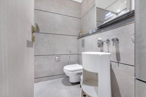 a bathroom with a toilet and a sink at Fantastic Studio resort style facilities - OFFER in Dubai