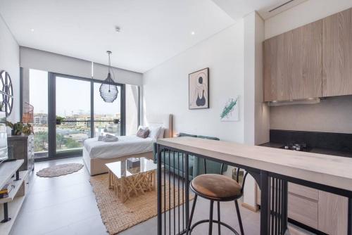 a kitchen and living room with a counter in a room at Fantastic Studio resort style facilities - OFFER in Dubai