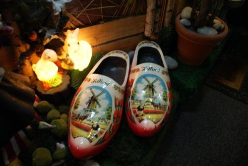 a pair of shoes with a painting of a ship at Nadia Hotel in Amsterdam