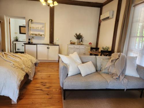 a living room with a couch and a kitchen at Marananga Cottages in Marananga