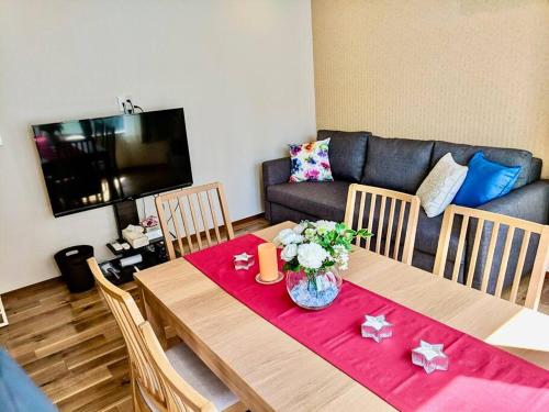 a living room with a table and a couch at Grato Terrace in Tokyo