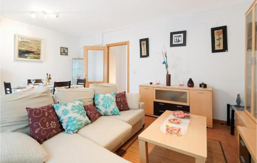 a living room with a white couch and a table at 3 Bedroom Cozy Home In La Algaba in La Algaba