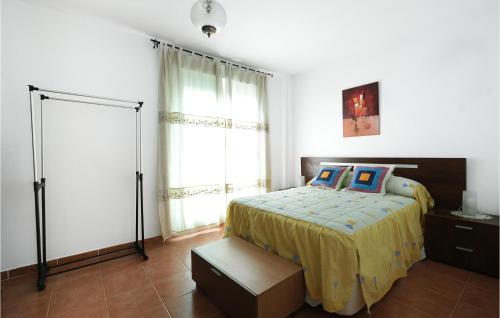 a bedroom with a bed and a large window at Stunning Home In La Algaba With 3 Bedrooms in La Algaba
