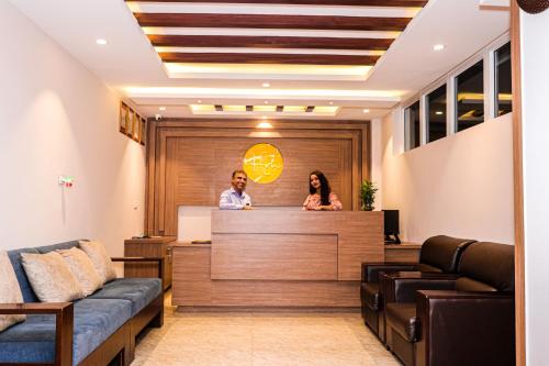a man and a woman standing at a reception desk at Hotel Mega & Apartment in Kathmandu