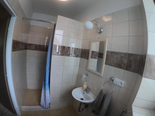a bathroom with a sink and a shower at Rodinný Penzion Kyjov in Kyjov