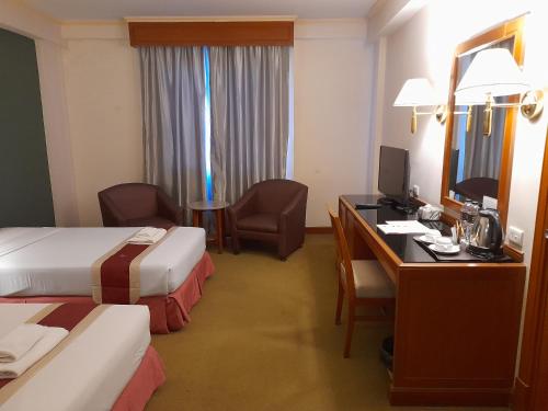 Ένα ή περισσότερα κρεβάτια σε δωμάτιο στο Songphanburi Hotel