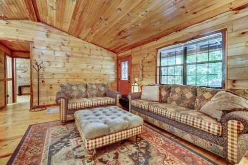 a living room with two couches and a rug at Private Broken Bow Cabin with Hot Tub and Gazebo! in Broken Bow