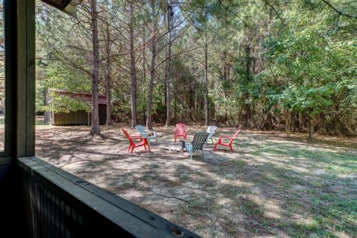 a group of chairs sitting in a yard at Private Broken Bow Cabin with Hot Tub and Gazebo! in Broken Bow