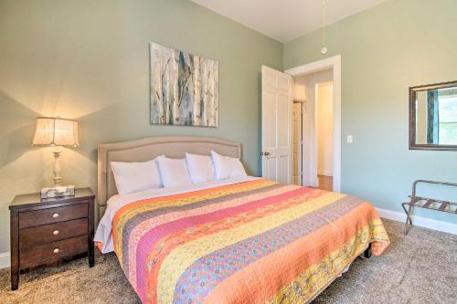a bedroom with a bed and a table with a lamp at Spacious Springfield Apt Less Than 4 Mi to Downtown! in Springfield