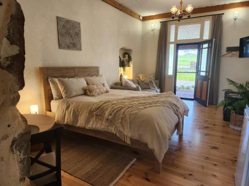 a bedroom with a large bed and a window at Marananga Cottages in Marananga