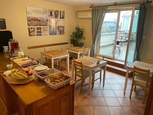 a kitchen with a table with fruit on it at Boulevard City Panzió - self check-in in Budapest