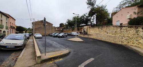 a street with cars parked on the side of the road at Magalas Studio in Magalas