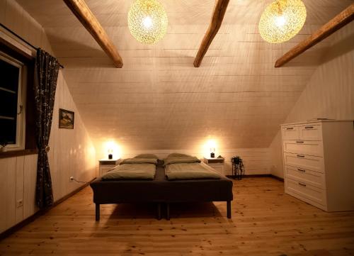 a bedroom with a bed in a room with two lights at Exclusive House in Olofström