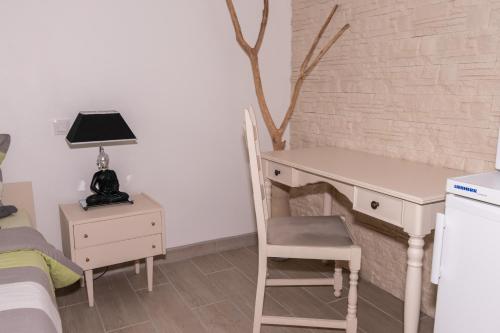 a bedroom with a desk and a chair and a bed at Private & Comfortable Apartments in Puttelange-aux-Lacs