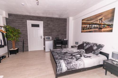 a bedroom with a bed and a desk in it at Private & Comfortable Apartments in Puttelange-aux-Lacs
