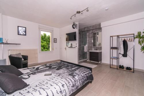 a bedroom with a large bed and a bathroom at Private & Comfortable Apartments in Puttelange-aux-Lacs