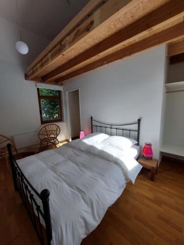 A bed or beds in a room at Le Gîte du Herdal