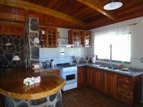 a kitchen with wooden cabinets and a wooden counter top at Heva Eco Lodge in Hanga Roa