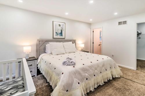 a white bedroom with a large bed and a table at Game Room and Yard Family Paradise in Pocono Summit in Pocono Summit Estates