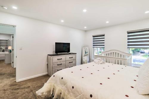 a white bedroom with a bed and a television at Game Room and Yard Family Paradise in Pocono Summit in Pocono Summit Estates