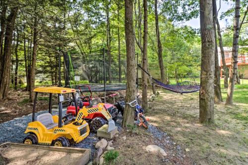 a playground with a toy tractor and a swing at Game Room and Yard Family Paradise in Pocono Summit in Pocono Summit Estates