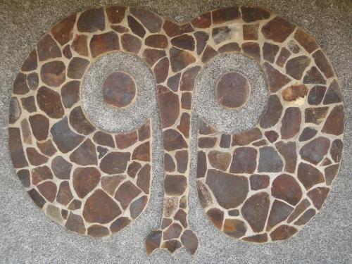 a close up of a number on the floor at Heva Eco Lodge in Hanga Roa