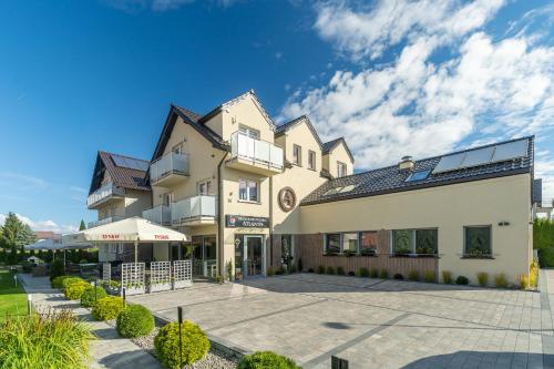 a large building with a courtyard in front of it at Villa Atlantis in Grzybowo