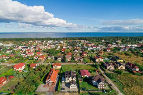 an aerial view of a town with houses and the ocean at Villa Atlantis in Grzybowo