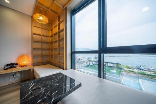 a room with a table and a large window at Louis Boutique Hotel in Changwon