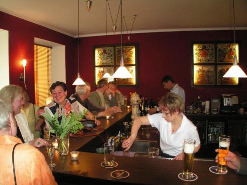 a group of people sitting at a bar at Hotel Störtebeker in Graal-Müritz