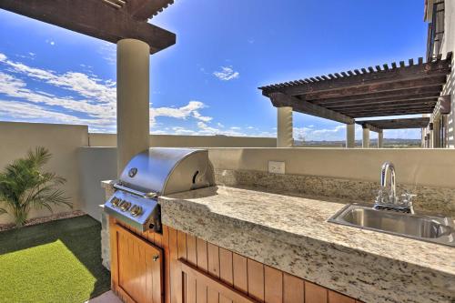 a kitchen with a sink and a grill on a patio at Luxe Cabo Casa w/ Own Rooftop Patio + Pool Access! in Cabo San Lucas