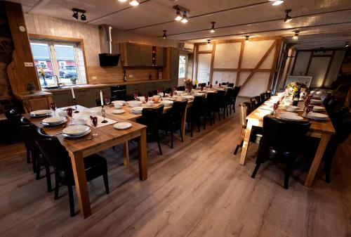 a dining room with long tables and chairs in it at Exclusive House in Olofström