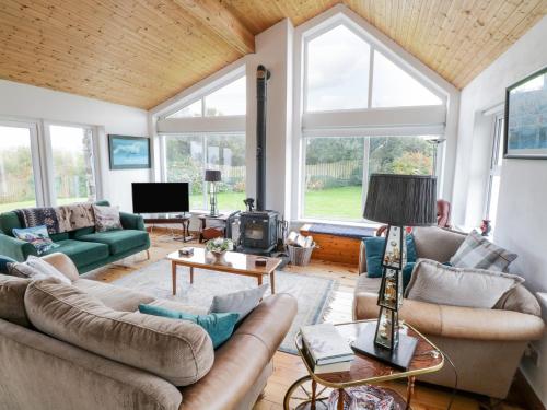 a living room with couches and a fireplace at Ben View in Renvyle