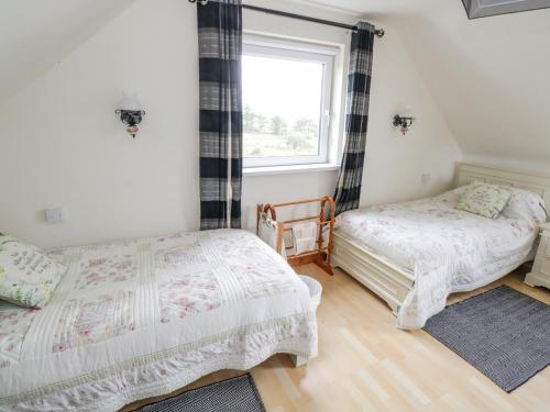 a bedroom with two beds and a window at Ben View in Renvyle