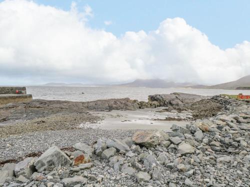 a group of rocks on the shore of a body of water at Ben View in Renvyle