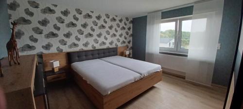 a small bedroom with a bed and a window at Ferienwohnung am Brohlbach in Gamlen