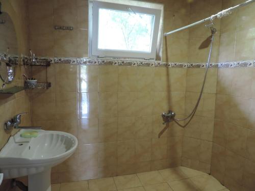 a bathroom with a shower and a sink at LUKA in K'obulet'i
