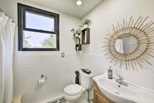 a bathroom with a toilet and a sink and a mirror at Garden Oasis Freeport Getaway Less Than 7 Mi to Long Beach in Freeport