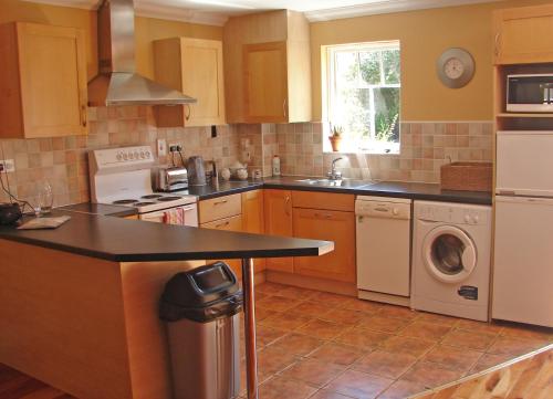 a kitchen with a sink and a dishwasher at Courtyard Holiday Cottage No 8 in Bettystown