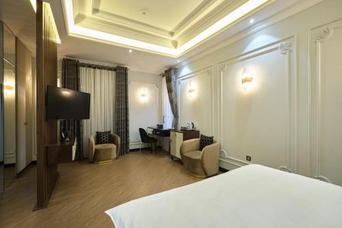 a hotel room with a bed and a desk at East Star Hotel in Samarkand