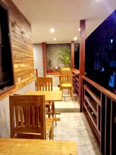 a dining room with wooden tables and chairs at RL Harbor Inn in El Nido