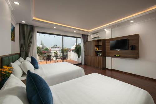 Postel nebo postele na pokoji v ubytování Hanoi Vacanza Premier Hotel